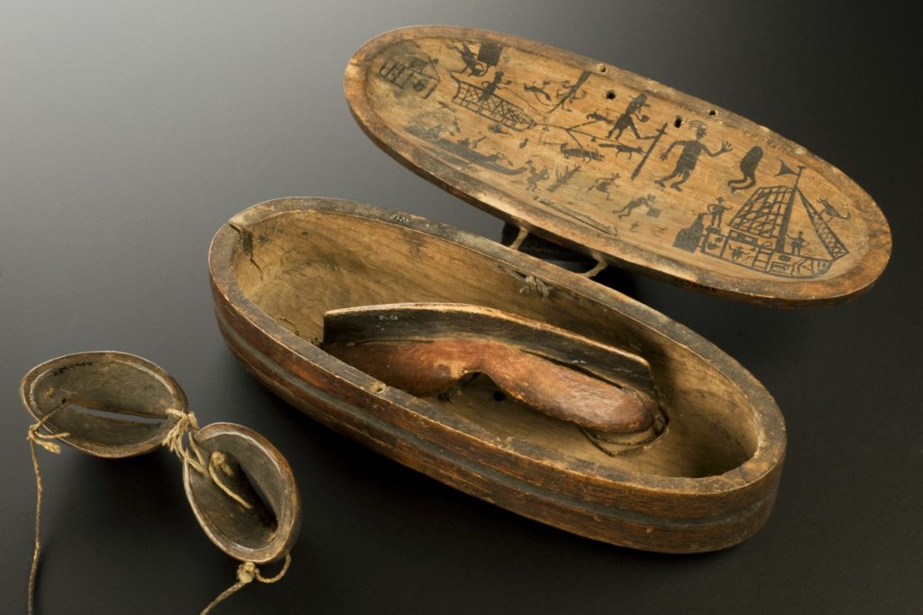 L0058740 Wooden snow goggles and case, Inuit, North America, 1801-190 Credit: Science Museum, London. Wellcome Images images@wellcome.ac.uk http://wellcomeimages.org Snow blindness is caused by sunlight reflecting off white snow and ice. This painful condition causes temporary loss of vision. The Inuit people in North America wore goggles to shield their eyes from such glare. These goggles are made from pine and rawhide. Slits in the rawhide eye pieces let the wearer see. They are kept in a wooden case decorated with hunting scenes. maker: Inuit people Place made: North America made: 1801-1900 Published: - Copyrighted work available under Creative Commons Attribution only licence CC BY 4.0 http://creativecommons.org/licenses/by/4.0/